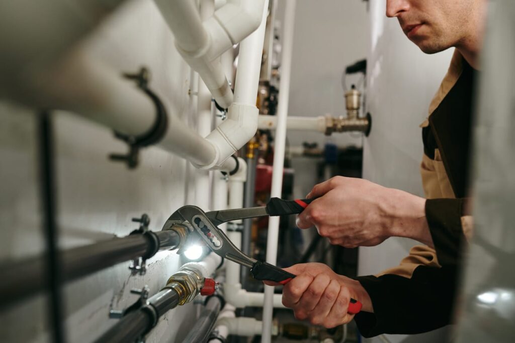 Plumbers maintaining commercial plumbing pipes in Pueblo